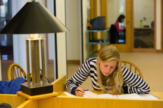 Clarke University Religisou Studies student studying in the library
