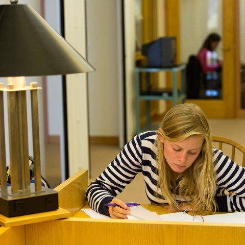 Clarke University Religisou Studies student studying in the library