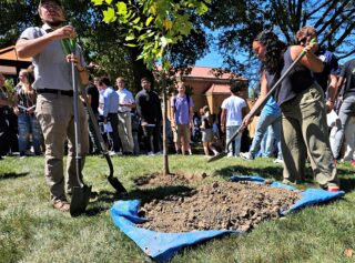Assisted by Groundskeeper Ben MacDonald, student planted a tulip tree along with their intentions for their time at Clarke. 