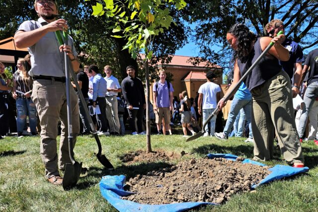 Assisted by Groundskeeper Ben MacDonald, student planted a tulip tree along with their intentions for their time at Clarke.