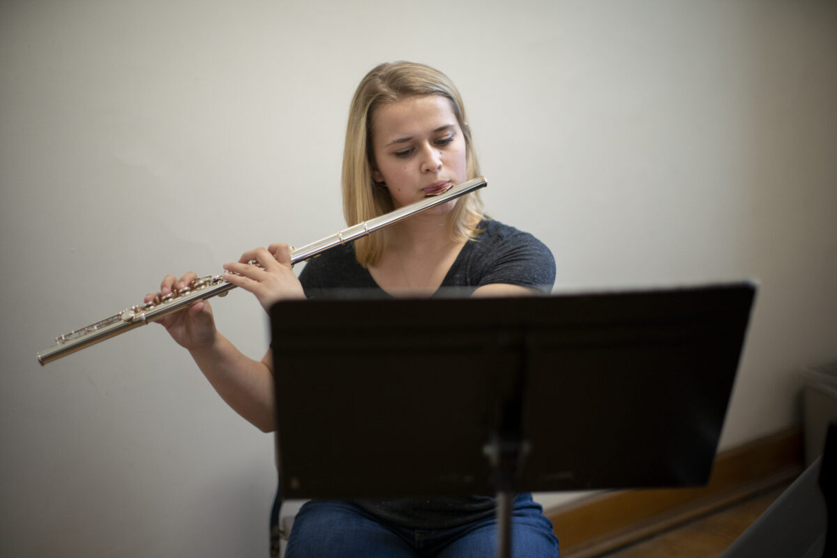 A young women playing a flute. - Full Size