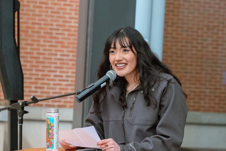 Female student speaking at a podium