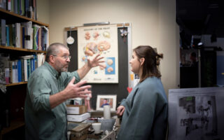 Tim B discussing with a Clarke University psychology student.