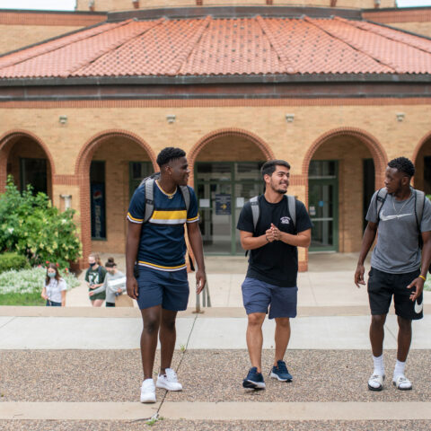 male-students-walking-outside