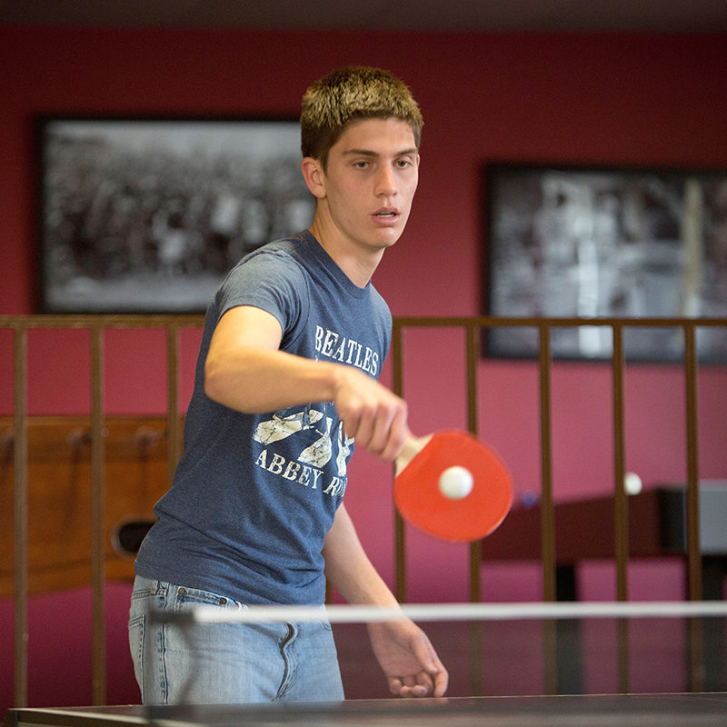 Clarke student playing ping-pong